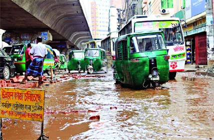 Plying of vehicles on road adjacent to Hanif Flyover point at Tikatuli turns risky as even light rains causing huge waterlogging. This photo was taken on Saturday.