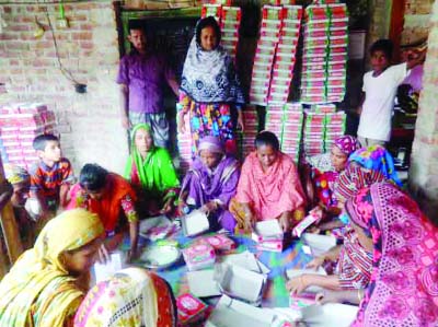 DINAJPUR( South) : Female members of Betdighi Mohona Mohila Somobay Samity making shopping bags.