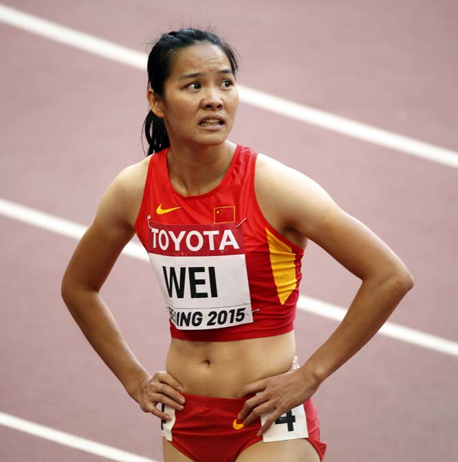 China's Wei Yongli pauses after women's 100m round one at the World Athletics Championships at the Bird's Nest stadium in Beijing on Sunday.