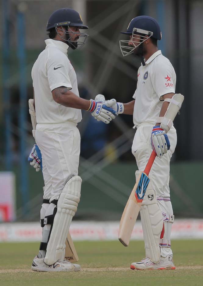 India's Murali Vijay (left) congratulates Ajinkya Rahane for scoring a half century during the fourth day's play of the second Test cricket match between Sri Lanka and India in Colombo, Sri Lanka on Sunday.