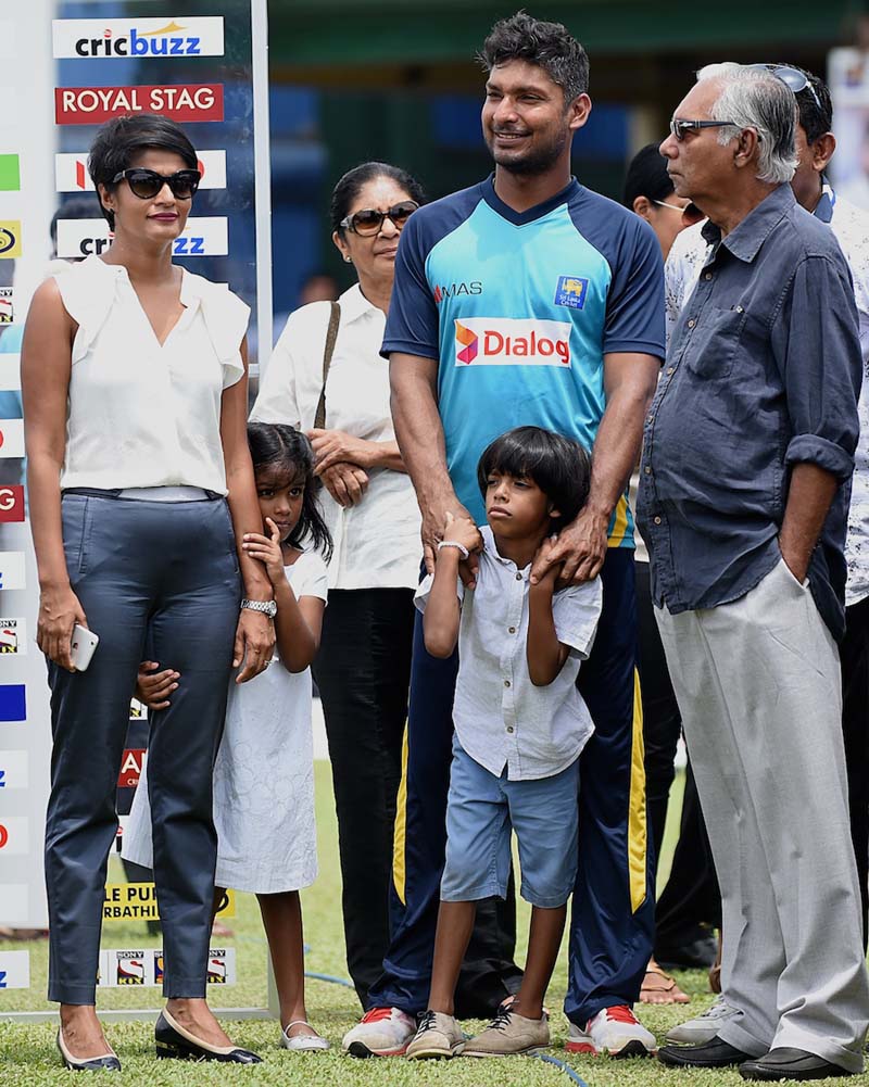 Sri Lankan cricketer Kumar Sangakkara (2R), his wife Yehali Sangakkara (L), son Kavith (front) and daughter Swyree (2L) look on at close of play on the fifth and final day of the second Test match between Sri Lanka and India at the P. Sara Oval Cricket St