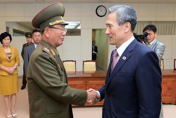 South Korean presidential security adviser Kim Kwan-jin, right, shakes hands with Hwang Pyong So, North Korea's top political officer for the Korean People's Army, after their meeting at the border village of Panmunjom in Paju, South Korea, on Tuesday.