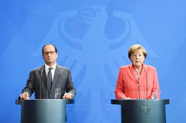 French President Francois Hollande and German Chancellor Angela Merkel seen at press conference in Berlin.