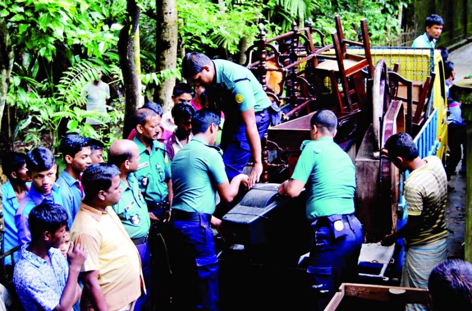 Police confiscating goods from the Sylhet house of Kamrul absconding key accused in the Rajon killing case on Tuesday.