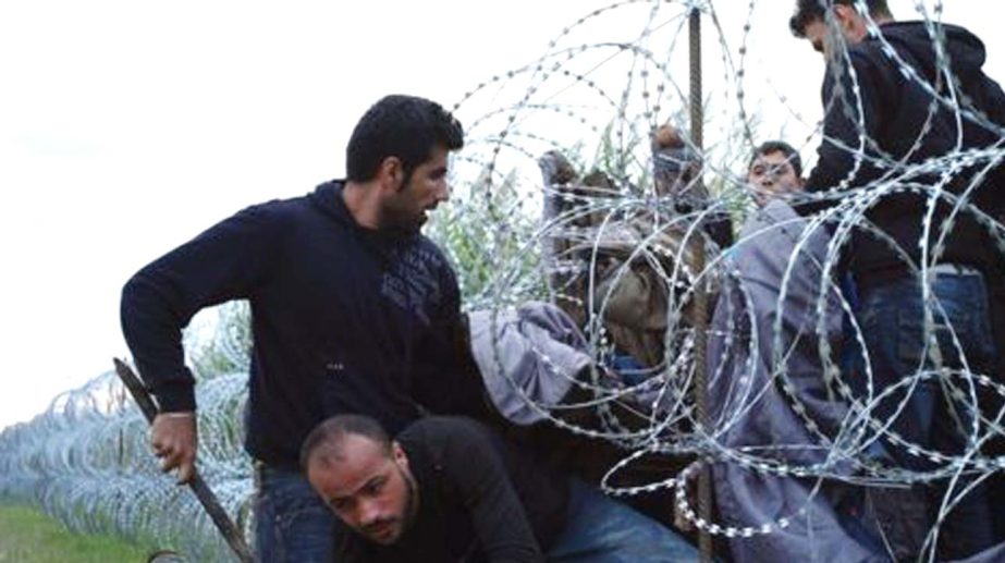 Migrants have been able to cross into Hungary before razor wire is replaced with a permanent fence .