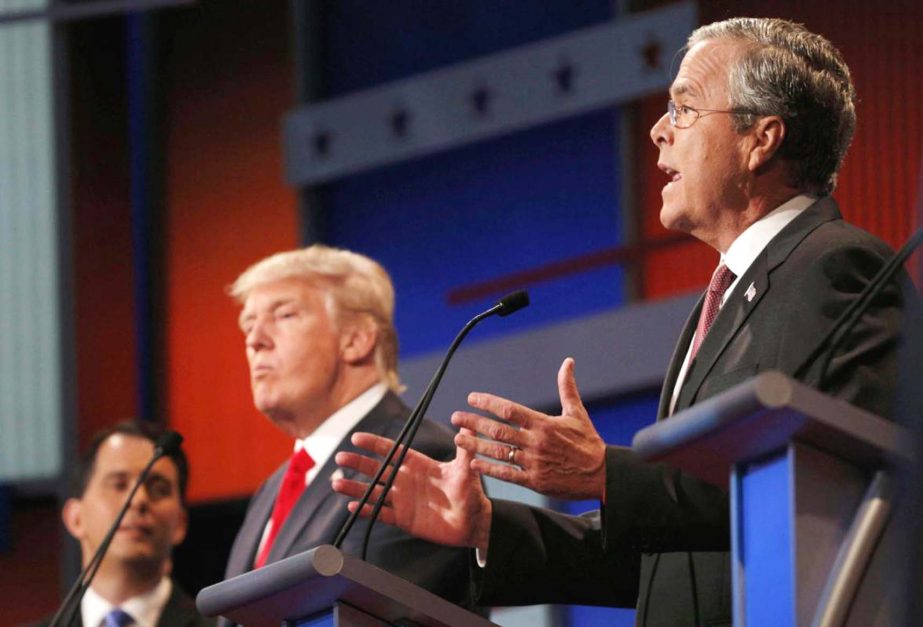 Republican 2016 US presidential candidate and former Florida Governor Jeb Bush (R) answers a question as Wisconsin Governor Scott Walker (L) and businessman Donald Trump (C) listen at the first official Republican presidential candidates debate.