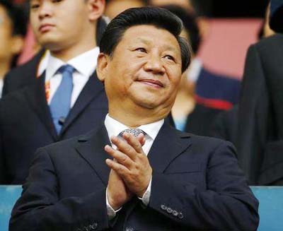 Chinese President Xi Jinping applauds during a function in Beijing