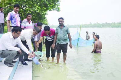 DINAJPUR: Mir Khairul Alam, DC, Dinajpur releasing fish fries in historic Ramsagar Digi on Wednesday.