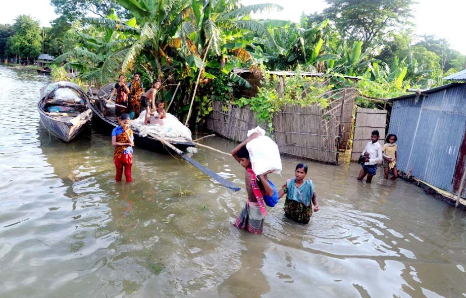 Dwellers of Katakhali area under Rajbari district along with their belongings going to the safer places as their homesteads were submerged through floodwaters. The snap was taken on Friday.