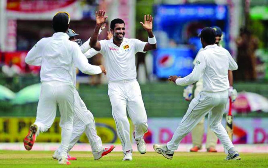 Sri Lanka's Dhammika Prasad (center) celebrates the dismissal of India's Lokesh Rahul with his teammates on the day one of the third Test cricket match in Colombo, Sri Lanka on Friday.