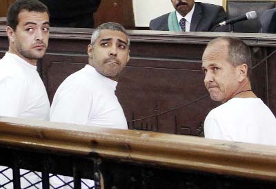 Mohamed Fahmy, Baher Mohamed and Peter Greste seen in a Cairo court.