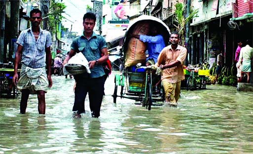 Chittagong's largest wholesale market of essential commodities, Khatunganj, Asadganj and adjoining areas went under knee-deep to waist-deep water following tidal surge due to influence of the full moon on Saturday. Banglar Chokh