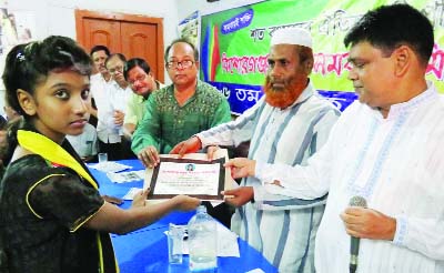 KISHOREGANJ: Officials of Kishoreganj Town Co-operative Society distributing scholarship certificates among meritorious students at its office on Saturday.