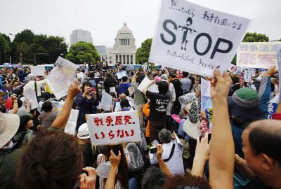 Protesters hold anti-war placards in front of the National Diet building during a rally in Tokyo on Sunday.