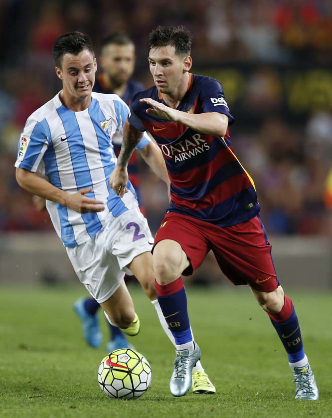 FC Barcelona's Lionel Messi from Argentina (right) duels for the ball against Malaga's Raul Albentosa during a Spanish La Liga soccer match at the Camp Nou Stadium in Barcelona, Spain on Saturday.