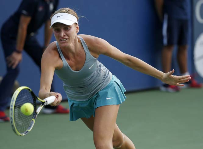 Sesil Karatantcheva of Bulgaria returns a shot to Belinda Bencic of Switzerland during the first round of the US Open Tennis tournament in New York on Monday.