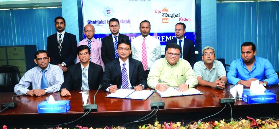 M Mushfiqur Rahman, Senior Executive Vice President of Shahjalal Islami Bank Limited and Asheq-ul-Islam partner of Mughal Kitchen sign MoU at the bank's head office on Wednesday. Under this agreement all VISA debit cardholders of the bank will get 15perc