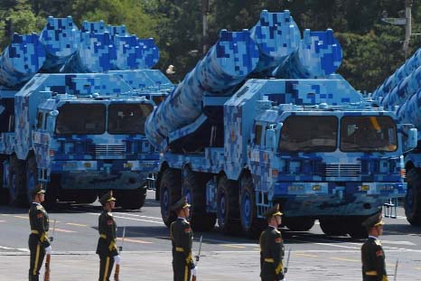 Military vehicles carrying shore-to-ship missiles participate in a parade at Tiananmen Square in Beijing on Thursday.