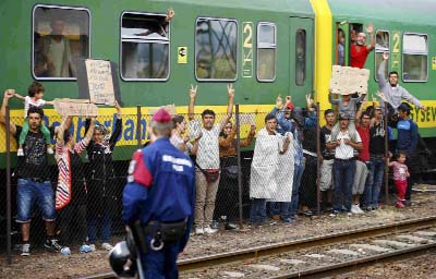 Migrants stage a protest in front of a train at Bicske railway station, Hungary on Friday..