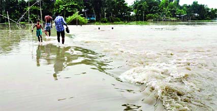 Flood situation at Jamalpur has been aggravating by the hilly waters as torrential rain continues for the last few days. Marooned people facing acute crisis of pure drinking water and food. Photo: FNS