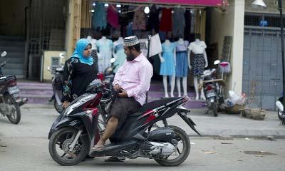 Muslims chatting along a street in Mandalay.