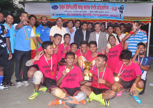 Adamjee Cantonment College, the champions of the Eastern University Inter-College Rugby Competition with the guests and officials of Bangladesh Rugby Federation pose for a photo session at the Paltan Maidan on Sunday.