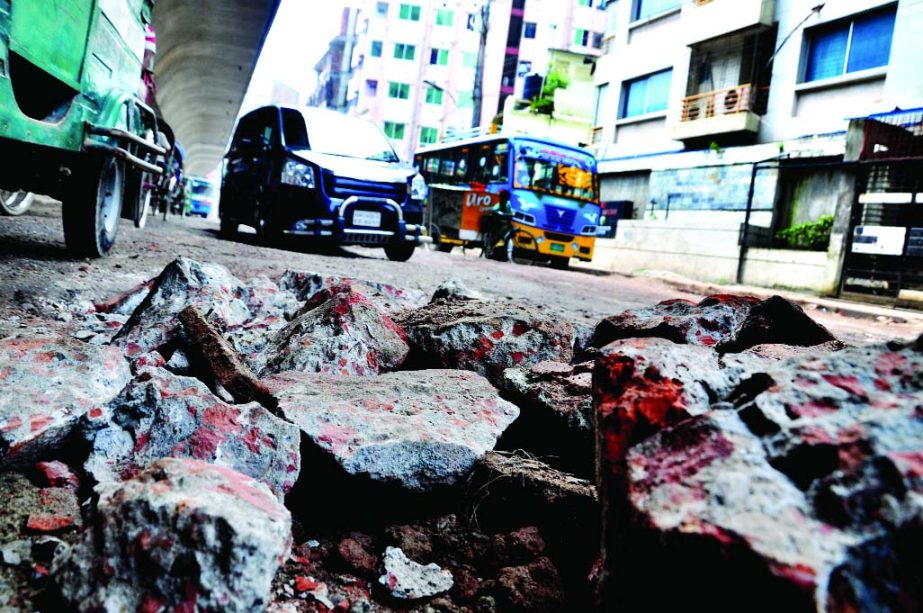 Big potholes that developed on city roads during the incessant rains were filled up by stones recently in the name of repairing posing threat to fatal accident anytime. This photo was taken from Wari area near Hanif Flyover on Sunday.