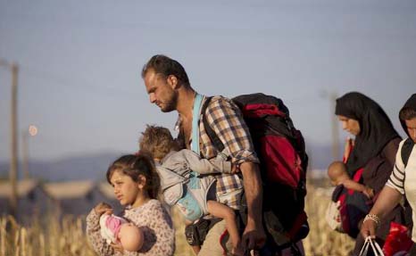 A group of migrants make their way after crossing the Macedonian-Greek border near Gevgelija, Macedonia, on Sunday.