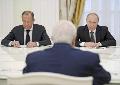 Russian President Vladimir Putin Â®, Foreign Minister Sergei Lavrov (L) and Syrian Foreign Minister Walid al-Muallem (back to camera) attend a meeting at the Kremlin in Moscow, Russia.