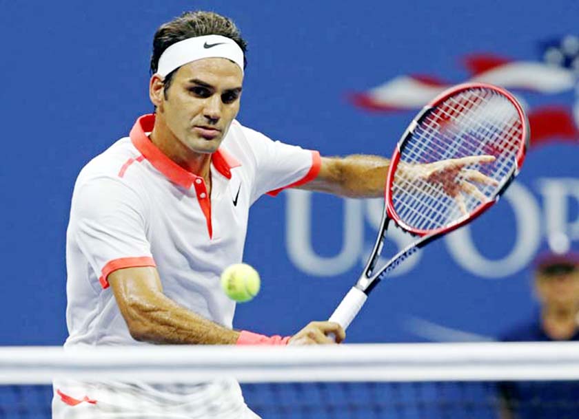 Roger Federer of Switzerland hits during his fourth round match against John Isner at the US Open tennis tournament in New York on Monday.