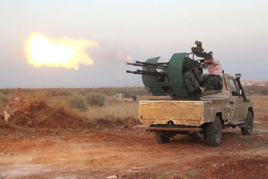 Rebel fighters clash with Syrian pro-government forces near Deir al-Zoghb in Idlib province.