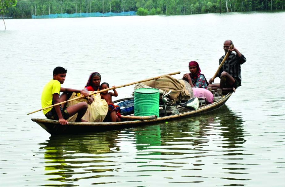 BOGRA: A flood affected family moving for a safer place with their households at Boraikandi area in Sariakandi Upazila on Tuesday.