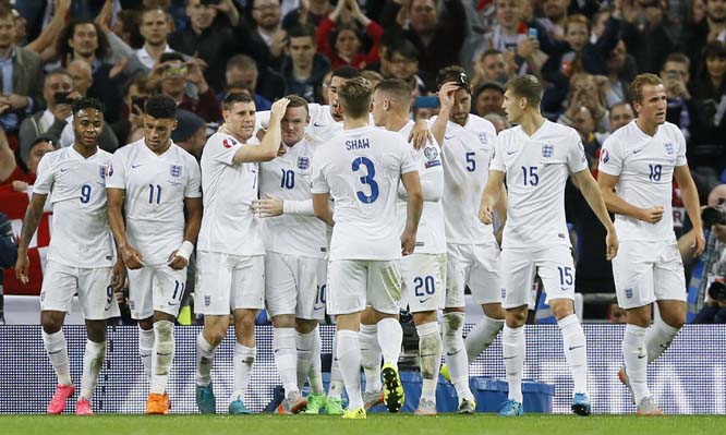 England's Wayne Rooney, No 10, is congratulated by his teammates after scoring form the penalty spot to score his sides second goal during the Euro 2016 Group E qualifying soccer match between England and Switzerland at Wembley stadium in London, England