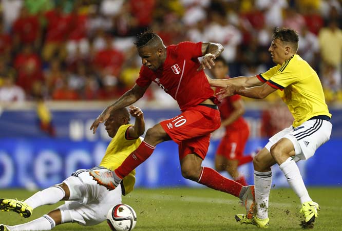 Peru's Jefferson Farfan (10) is fouled by Colombia's Frank Fabra (28) in the penalty box during the second half in an international friendly soccer match in Harrison NJ on Tuesday. A penalty kick was awarded as Farfan converted to tie the game at one in