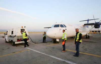 Syrian technicians work on an airplan at al-Basel International Airport in the coastal city of Latakia.
