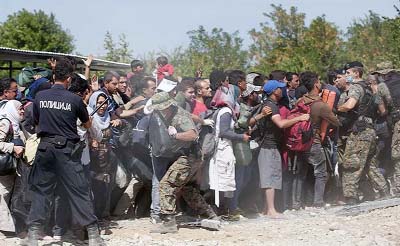 Refugees are detained by police at Padborg Station after crossing the Danish-German border on Wednesday.