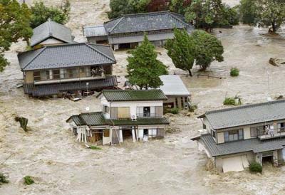 Residents are seen as they wait for rescue helicopters at a residential area flooded by the Kinugawa river, caused by typhoon Etau, in Joso, Ibaraki prefecture, Japan
