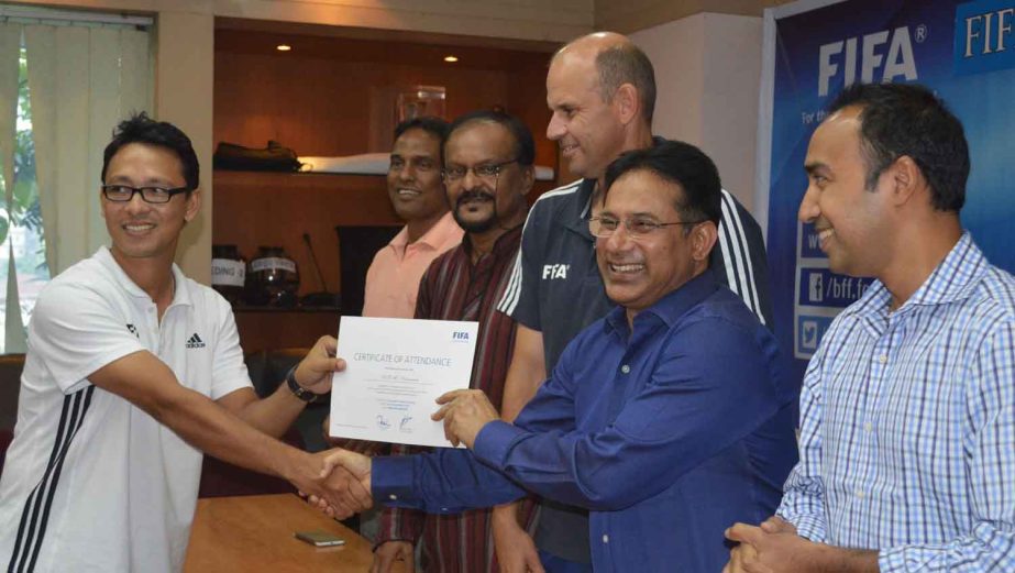 Senior Vice-President of Bangladesh Football Federation (BFF) Abdus Salam Murshedy giving away a certificate to a participant of FIFA Elite Goalkeeping Coaching Course at the conference room of BFF House on Thursday.