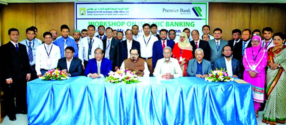 BazlulHaqueHaroon, MP, Director of Premier Bank Ltd poses with the participants of a workshop on Islamic banking jointly organized by the bank and Central Shariah Board for Islamic Banks of Bangladesh at the bank's head office on Saturday. Managing Direc