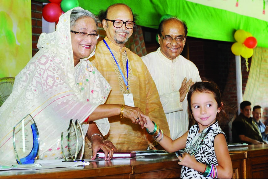 Prime Minister Sheikh Hasina handing over award to the winners of drawing and essay competition organized in observance of birth anniversary of Father of the Nation Bangabandhu Sheikh Mujibur Rahman at Ganobhaban in the city on Saturday. BSS photo