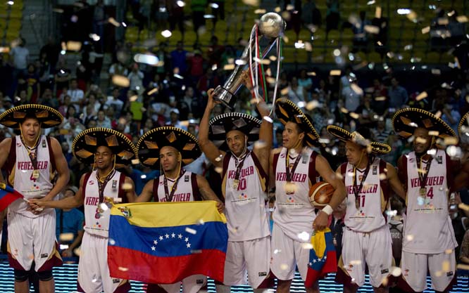 Captain Jose Vargas holds up the trophy as Venezuela's player wearing Mexican 'sombreros' celebrate their 76-71 victory over Argentina during the FIBA Americas Championship final basketball game in Mexico City on Saturday.