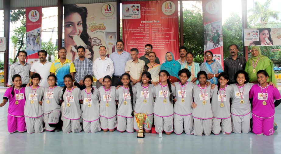 Members of Viqarunnisa Noon School & College, the champions of the Girls' Group of the Polar Icecream 23rd School Handball Tournament with the guests and officials of Bangladesh Handball Federation pose for a photo session at the Shaheed (Captain) M Mans