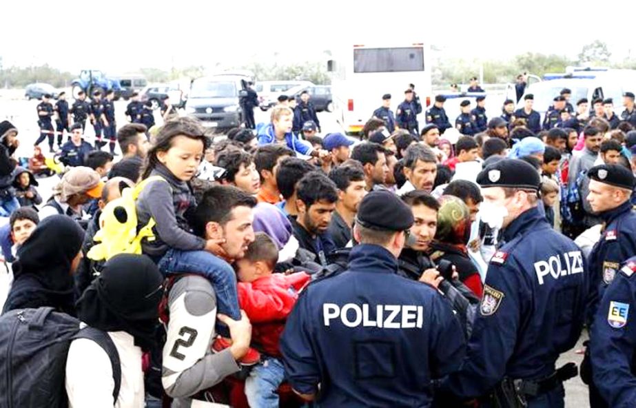 Migrants wait to board buses in Nickelsdorf, Austria September 14, 2015.