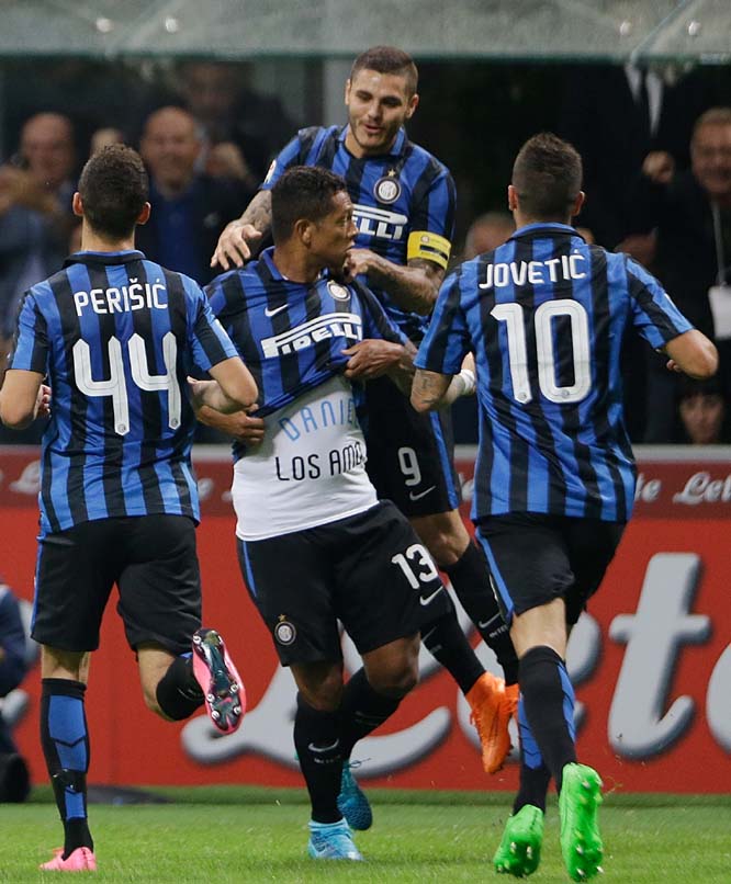Inter Milan's Fredy Guarin (center) celebrates with his teammates after scoring during a Serie A soccer match between Inter Milan and AC Milan, at the San Siro Stadium in Milan, Italy on Sunday.
