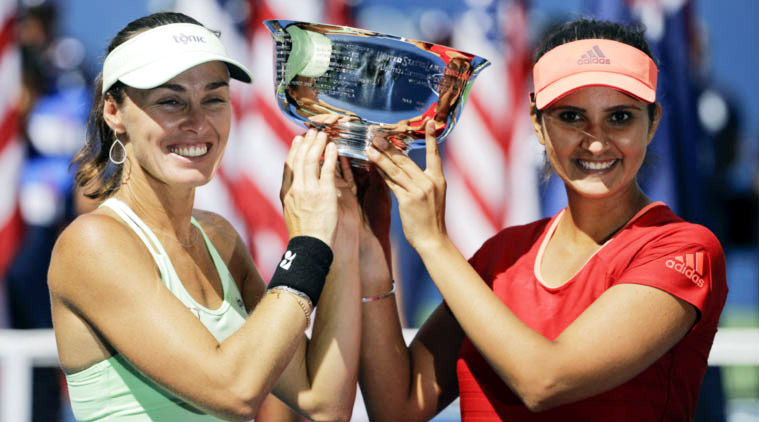 Martina Hingis and Sania Mirza with the 2015 US Open women's doubles trophy after beating Casey Dellacqua of Australia and Yaroslava Shvedova of Kazakhstan in the final at the USTA National Tennis Center in New York on Sunday. Reuters photo