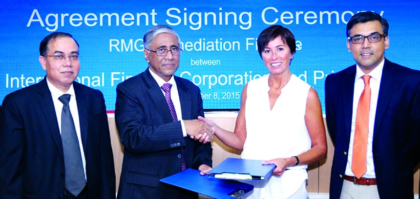 Ahmed Kamal Khan Chowdhury, Managing Director of Prime Bank Limited and Inessa Tolokonnikova, Manager of Financial Markets South Asia Region of IFC, exchanging documents of RMG remediation finance agreement in the city recently. Under this agreement, the