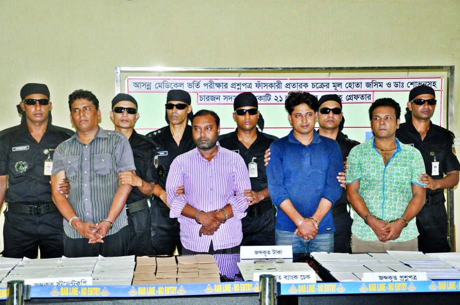 RAB team arrested four persons for alleged involvement in leakage of medical entrance test question papers and seized answer sheets and cheques from their possession on Wednesday.