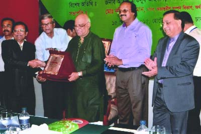 NARSINGDI; Babu Subosh Chandra Das receiving crest from Finance Minister Abul Maal Abdul Muhith as highest tax payer in Narsingdi district in the fiscal year 2014-15 in at a function in the city on Tuesday. Among others , State Minister of Financ