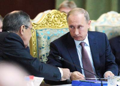Russian President Vladimir Putin listens to Russia's Foreign Minister Sergey Lavrov, left, at the meeting of the Collective Security Treaty Organisation (CSTO) in Dushanbe, Tajikistan