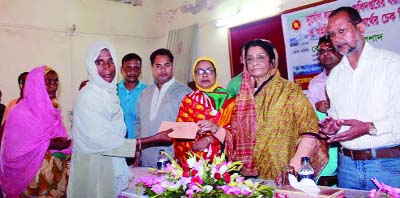 MYMENSINGH: Leader of the Opposition in Parliament Begum Raushan Ershad MP distributing CI sheet and cash money among the distressed families at a function at Mymensingh Sadar Zilla Parishad auditorium recently.